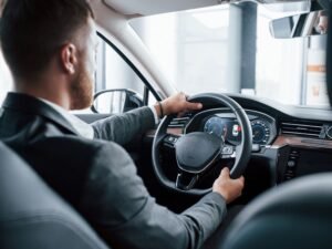 modern-businessman-trying-his-new-car-automobile-salon